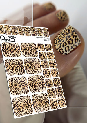 Sheet of leopard print nail art stickers with a sample application on a thumb.