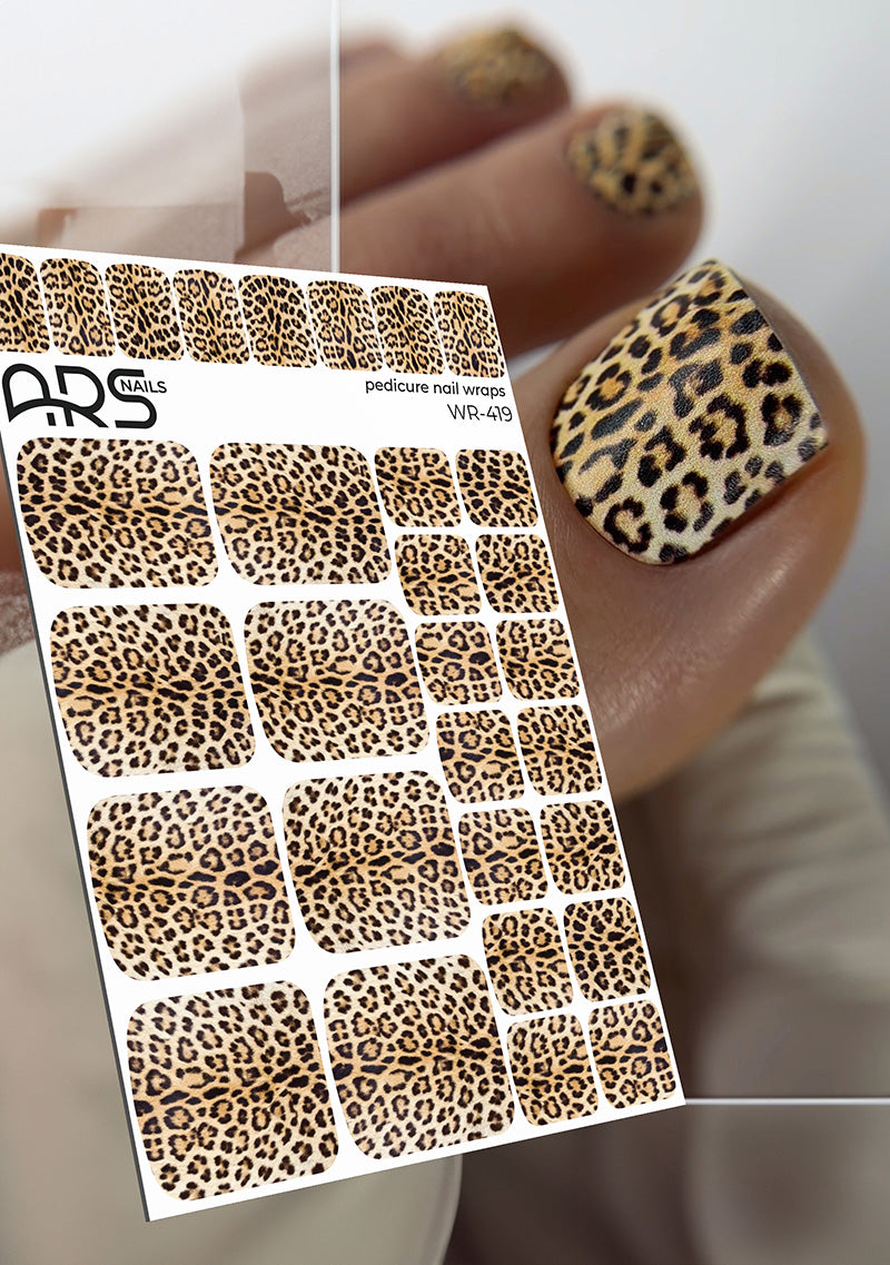 Sheet of leopard print nail art stickers with a sample application on a thumb.