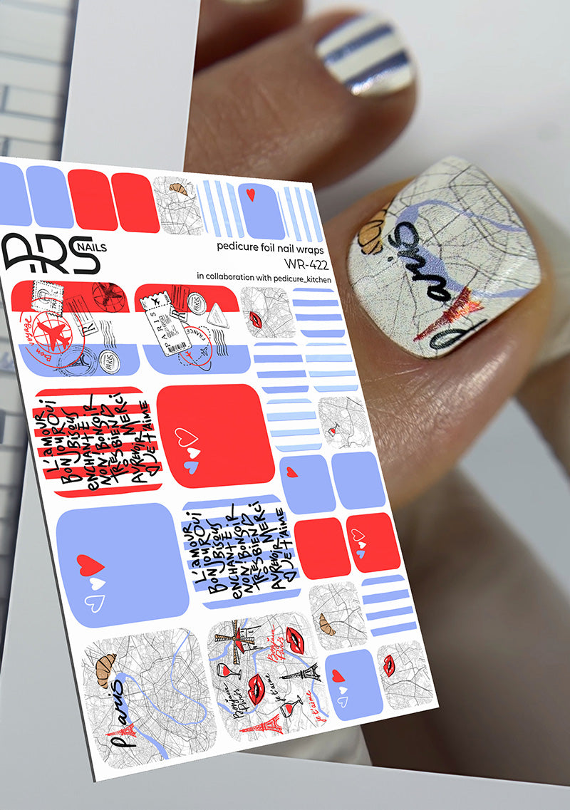 Sheet of nail art stickers with various designs held by a hand with painted nails.