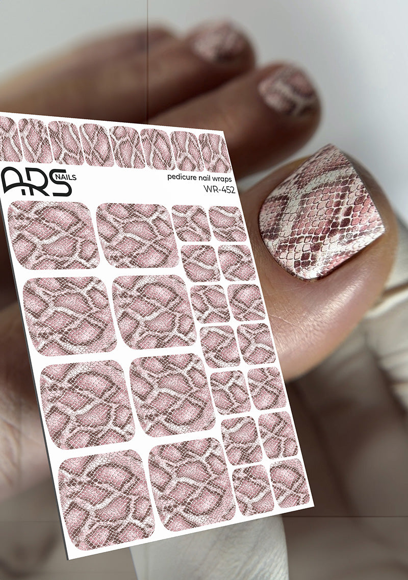 Sheet of snake patterned nail wraps with a hand wearing a nail with the design.