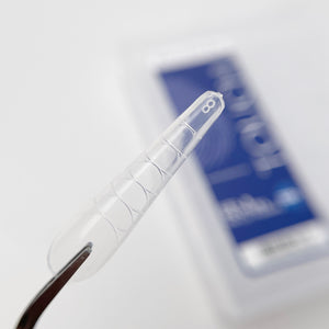 Clear phone case on a white background with a blurred blue product in the background