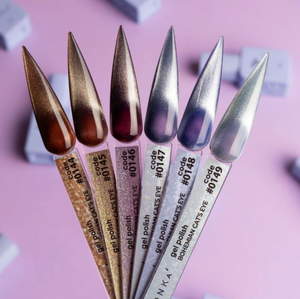 Set of gel polish applicators with metallic tips on a pink background