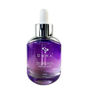 Purple bottle of Dinka dry cuticle oil with a white cap on a white background