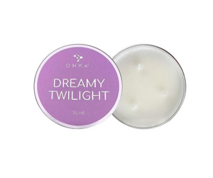 Candle in a tin labeled 'Dreamy Twilight' by DNKA on a white background