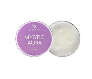 DNKA Mystic Aura candle in a tin with purple lid on a white background