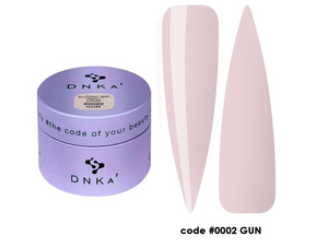 DNKA nail art product with a purple container and two white nail tips on a white background