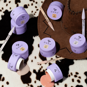 DNKA cosmetic jars and applicators on a patterned surface