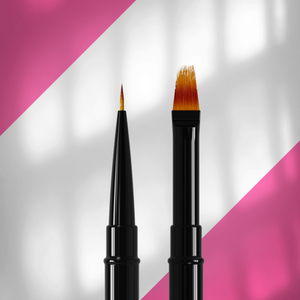 Two makeup brushes with black handles on a pink and white background