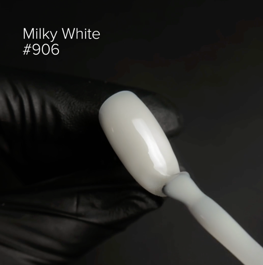 White nail polish brush with a milky white color swatch labeled #906 on a dark background.