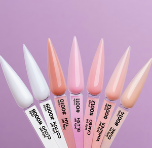 Set of nail polish bottles with long, pointed nails on a purple background
