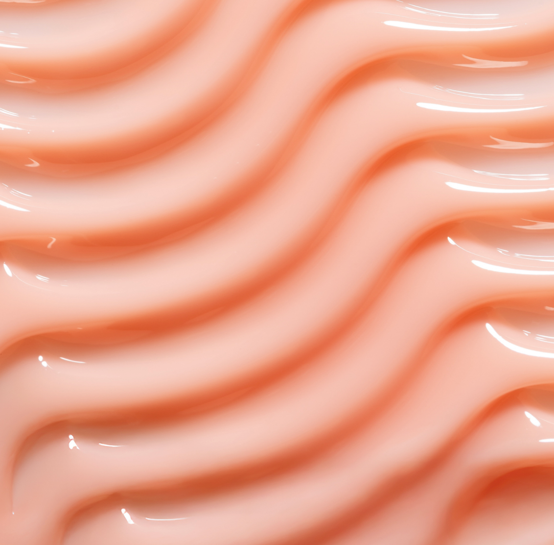 Close-up of smooth, wavy peach-colored surface