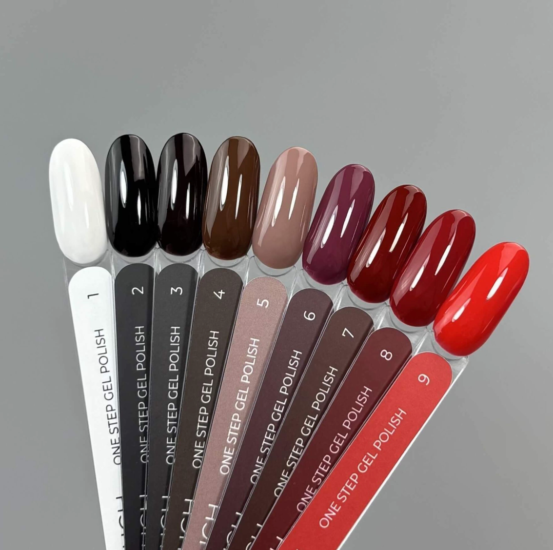 Row of one-step gel polish applicators with nail colors on a gray background