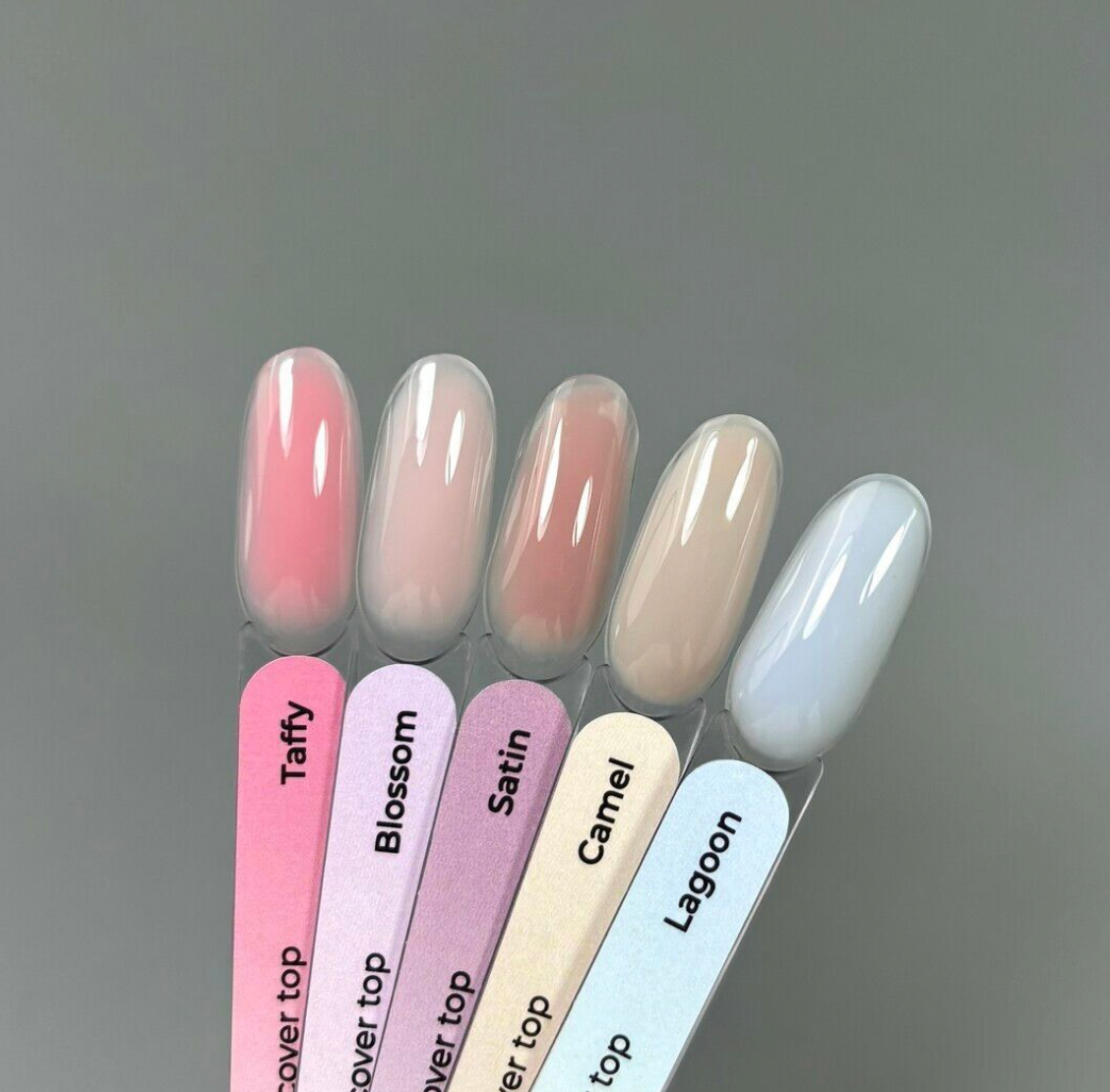 Set of nail polish samples with names on a gray background