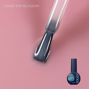 Nail polish brush and bottle with 'TOUCH' branding on a pink background