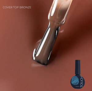 Nail polish brush with 'Cover Top Bronze' color swatch on a brown background, featuring the Touch nail polish brand.