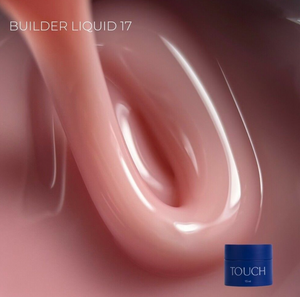 Close-up of pink liquid with a blue container labeled 'TOUCH' on a pink background.