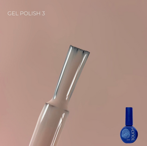 Nail art brush and blue nail polish bottle on a beige background