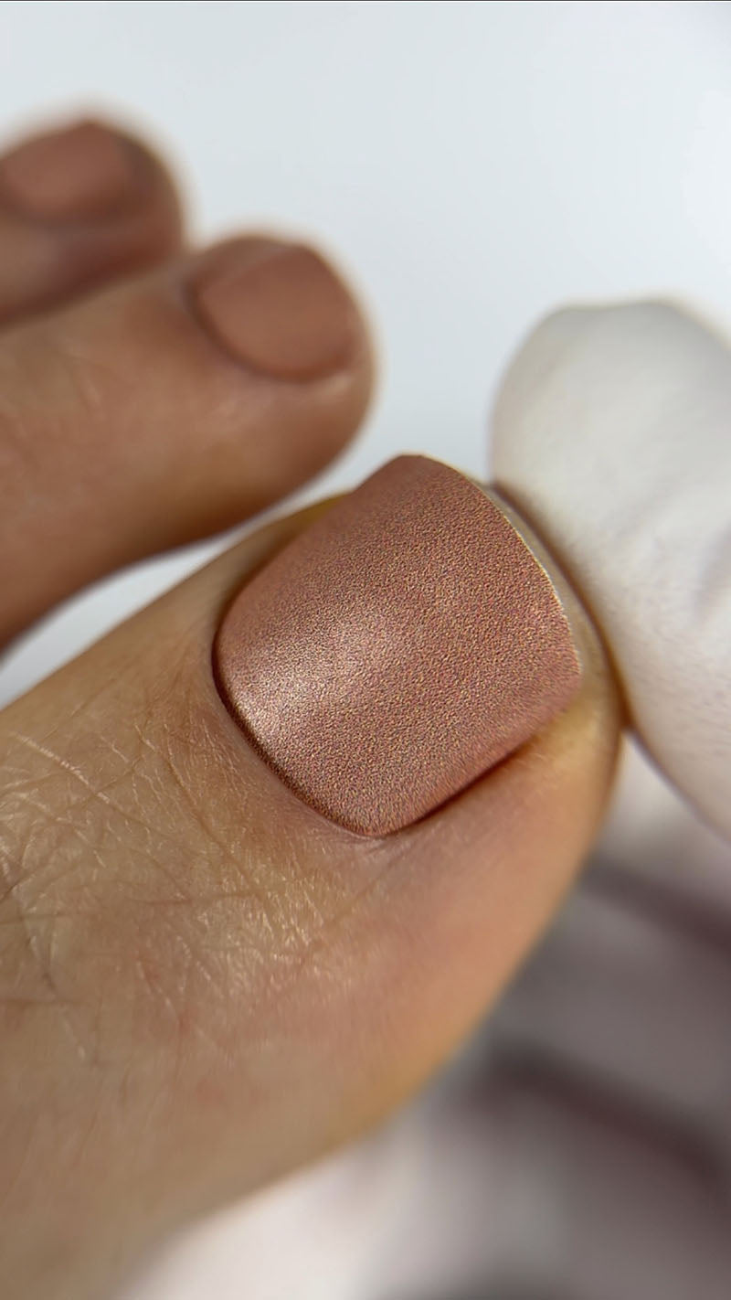 Close-up of a foot with a pedicure nail wrap on a white background