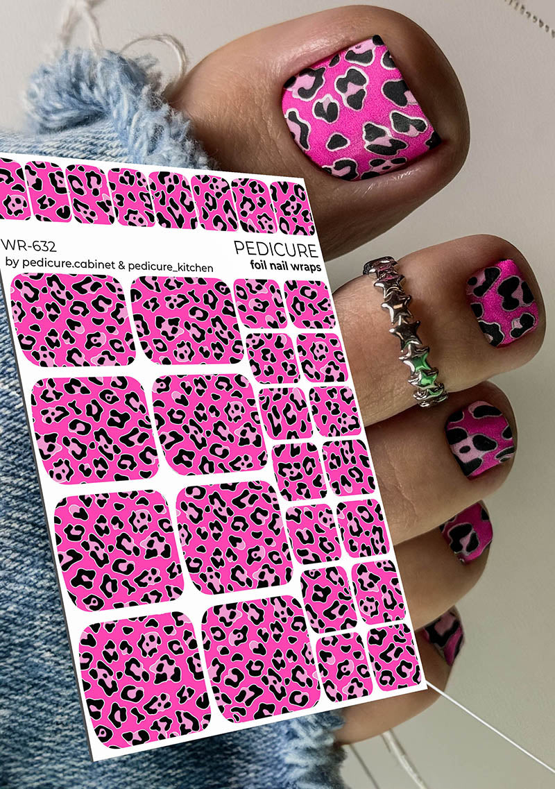 Pink leopard print nail wraps with a hand wearing a pink and black patterned nail design.