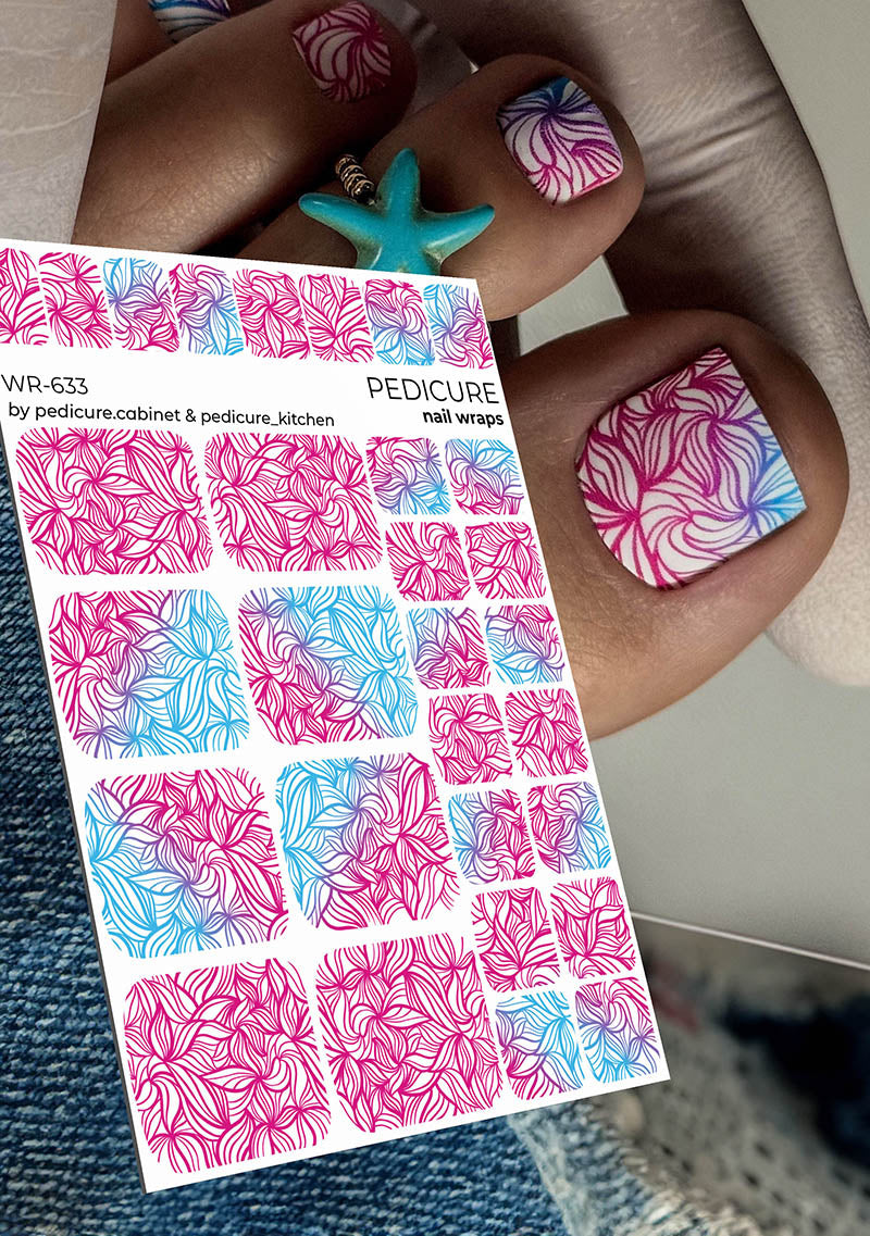 Nail wrap sheet with pink and blue designs held by a person with colorful nails.