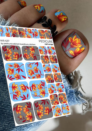 Nail wrap sheet with floral design held by a person with matching nail art.
