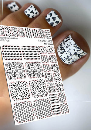 Nail wrap sheet with black and white designs held by a hand with similarly styled nails.