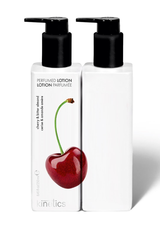 Two Kinetics Perfumed Lotion bottles side-by-side on a white background. The left bottle is white with a black pump and features a graphic of a red cherry with a green stem.