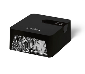 A black Kinetics UV lamp with a transparent acrylic front showing the internal light tubes, photographed on a clean white background.