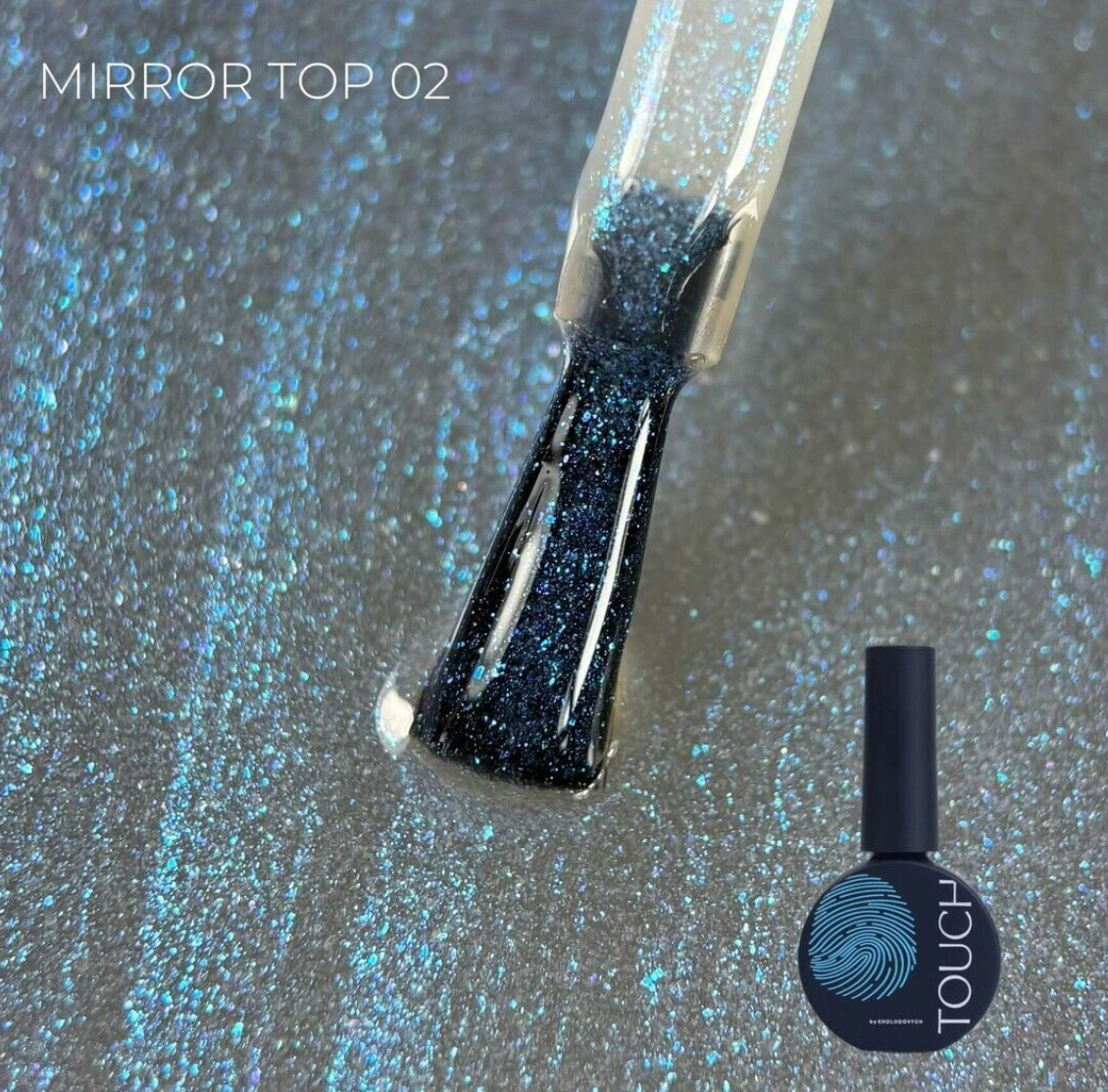 A bottle of TOUCH Mirror Top 02 nail polish with a brush showing the glittery blue-black polish, set against a sparkly silver-blue background with the product bottle shown in the lower right.