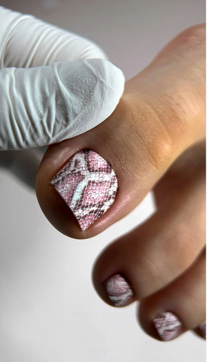 Close-up of a hand with textured nail polish wearing a white glove.