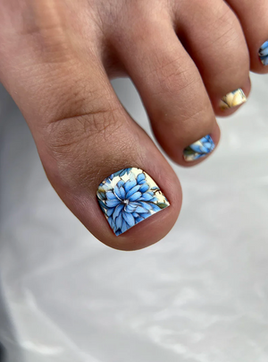 Close-up of a hand with floral nail art on a white background