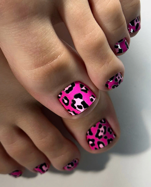 Nails with pink leopard print design on a neutral background