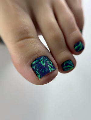 Nails with a blue and green leaf pattern on a neutral background