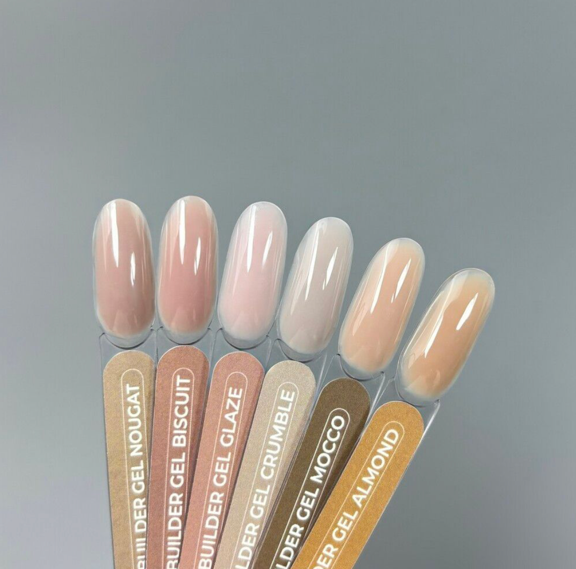 TOUCH Builder Gel Yogurt swatches in peach and pink tones on gray background