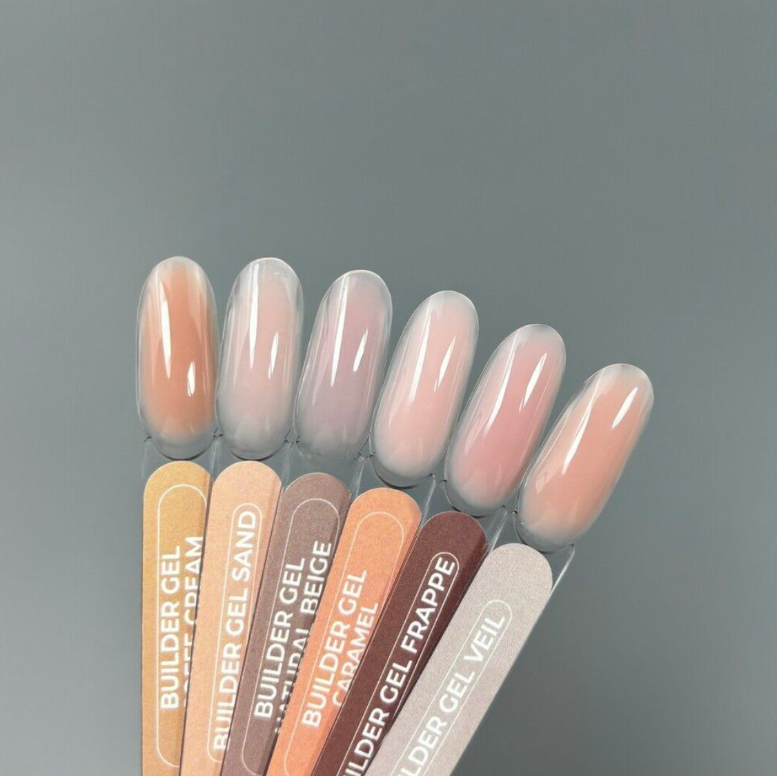 TOUCH Builder Gel Yogurt swatches in light pink and sand tones on gray background