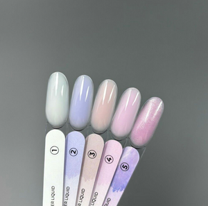 Set of pastel-colored nail polish swatches on a gray background