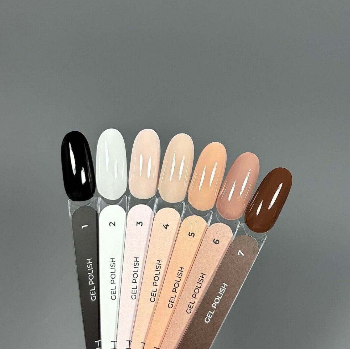 Set of gel nail polish samples on a gray background