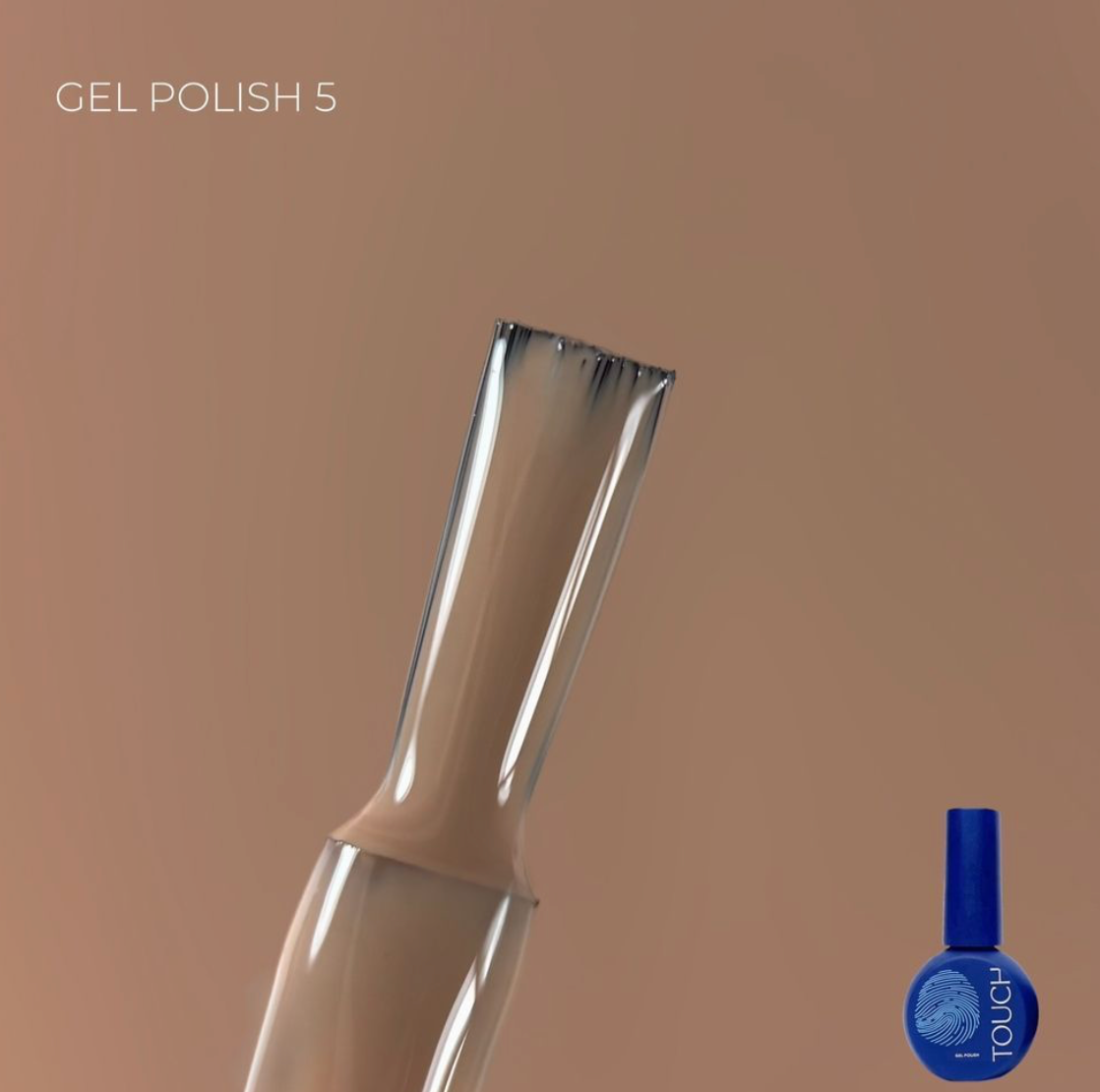Gel polish bottle with a brush applicator on a brown background
