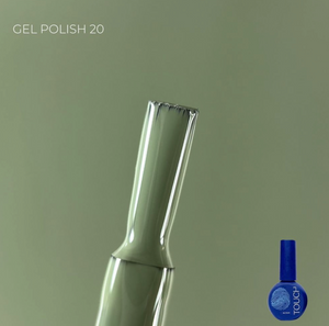 Green nail polish brush with a blue bottle labeled 'Touch' on a green background