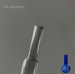 Nail art brush and blue gel polish bottle on a gray background