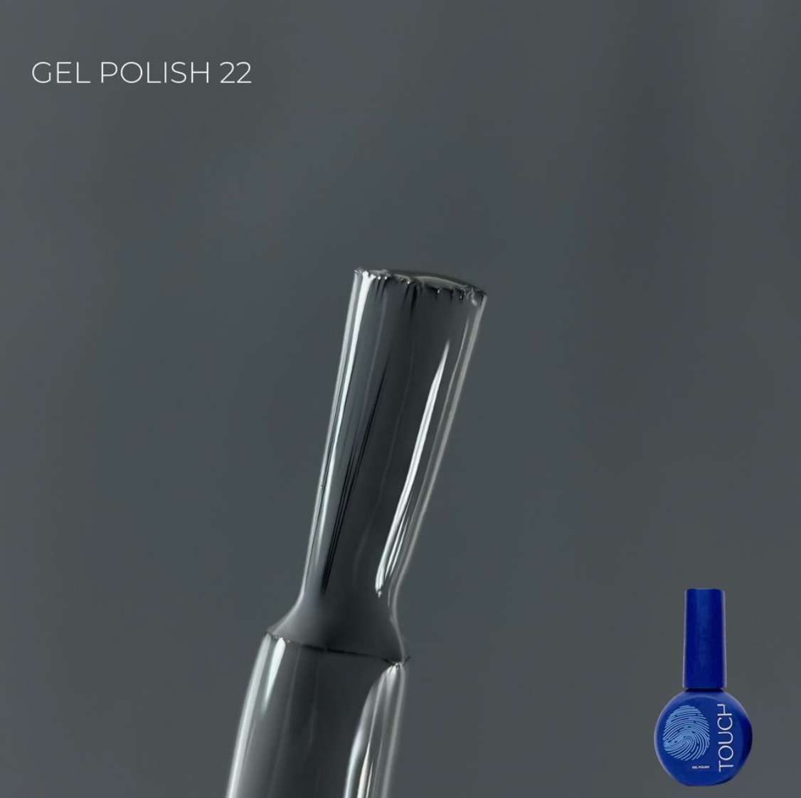 Nail art brush with a blue bottle labeled 'Touch' on a gray background