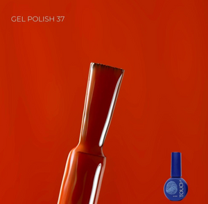 Gel polish brush with a bottle of Touch gel polish on an orange background