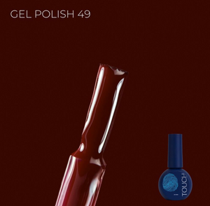Gel polish bottle with a dark red color on a dark brown background