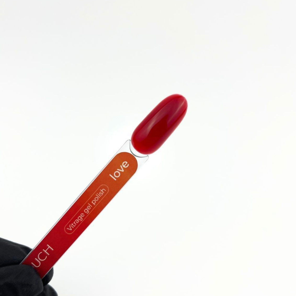 Red nail polish with a visible brand name on a white background