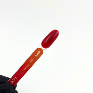 Red nail polish with a visible brand name on a white background