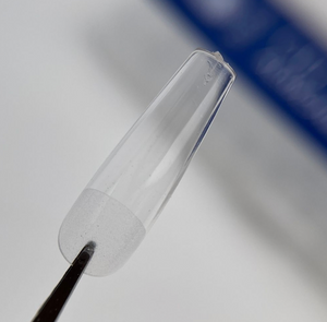 Clear glass cone with a black handle on a gray background